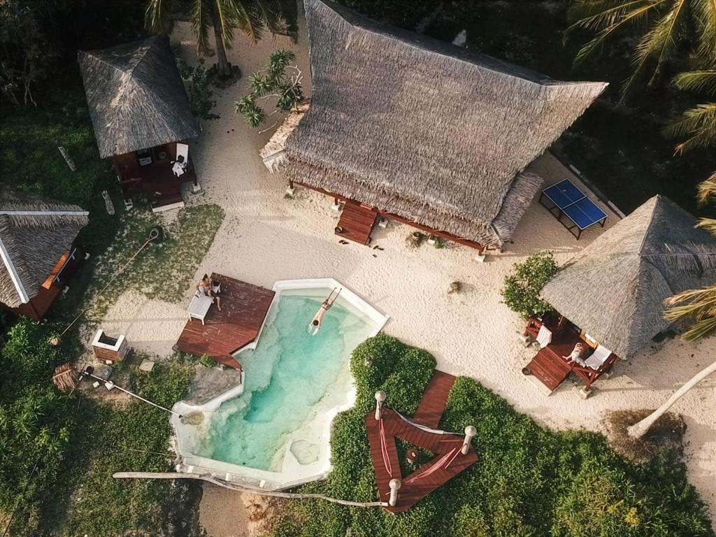 an aerial view of a house with a swimming pool at Simeulue Surflodges in Lasikin