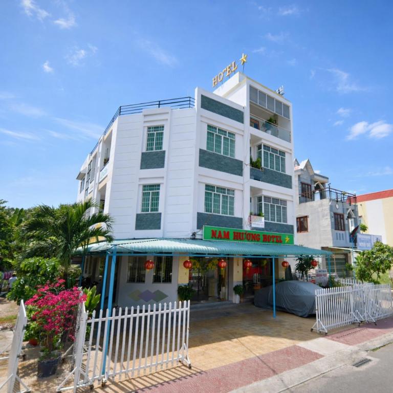 a large white building with a sign on it at Nam Phương Hotel Sa Đéc in Sa Ðéc