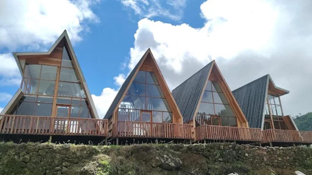 a house on a hill with large windows at Padangsari Cabin 2 in Diyeng