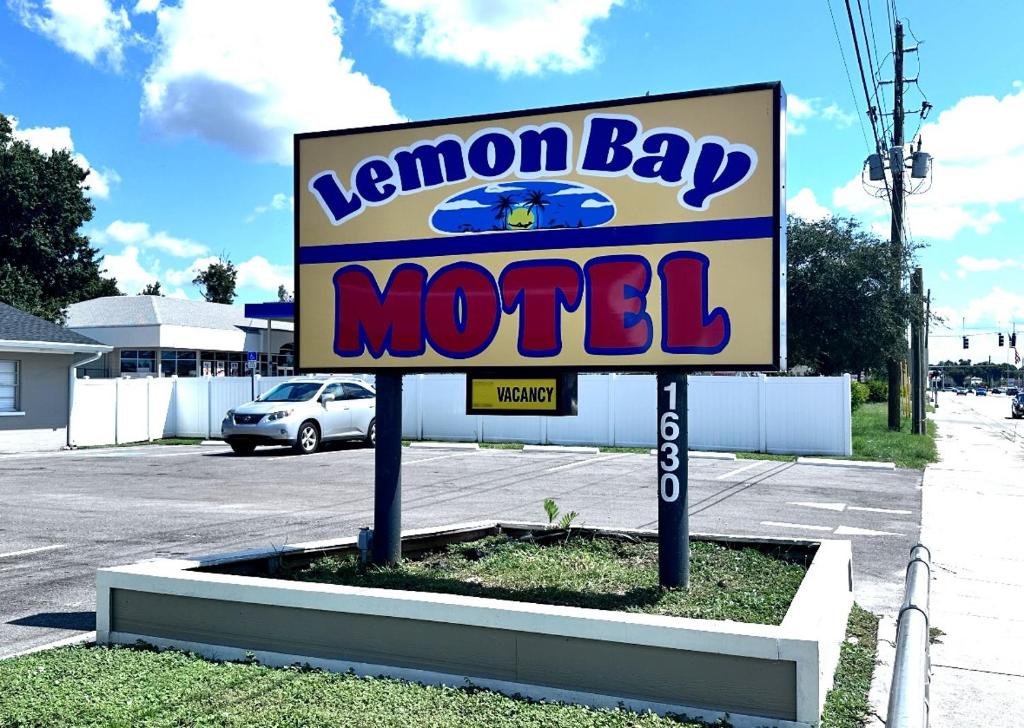 a sign for a kennon bay motel in a parking lot at Lemon Bay Motel in Englewood