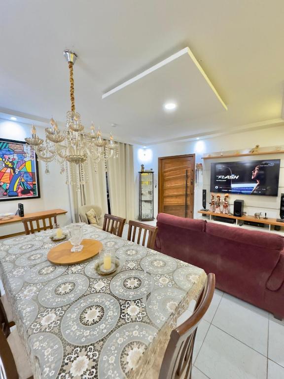 a dining room with a table and a couch at 4 quartos na Folia de Olinda in Olinda
