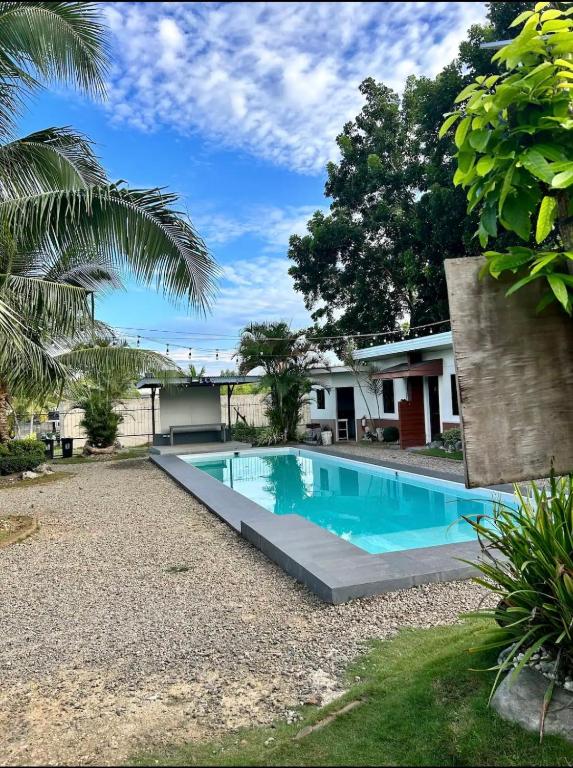 a swimming pool in the yard of a house at Ashelma resort in Dauis