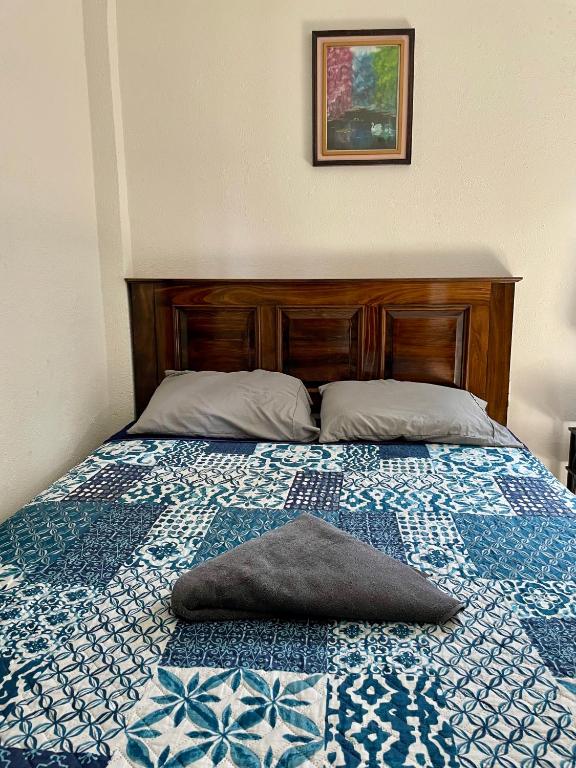 a bed with a pillow on top of it at Casa Mama Wela in San Pedro La Laguna