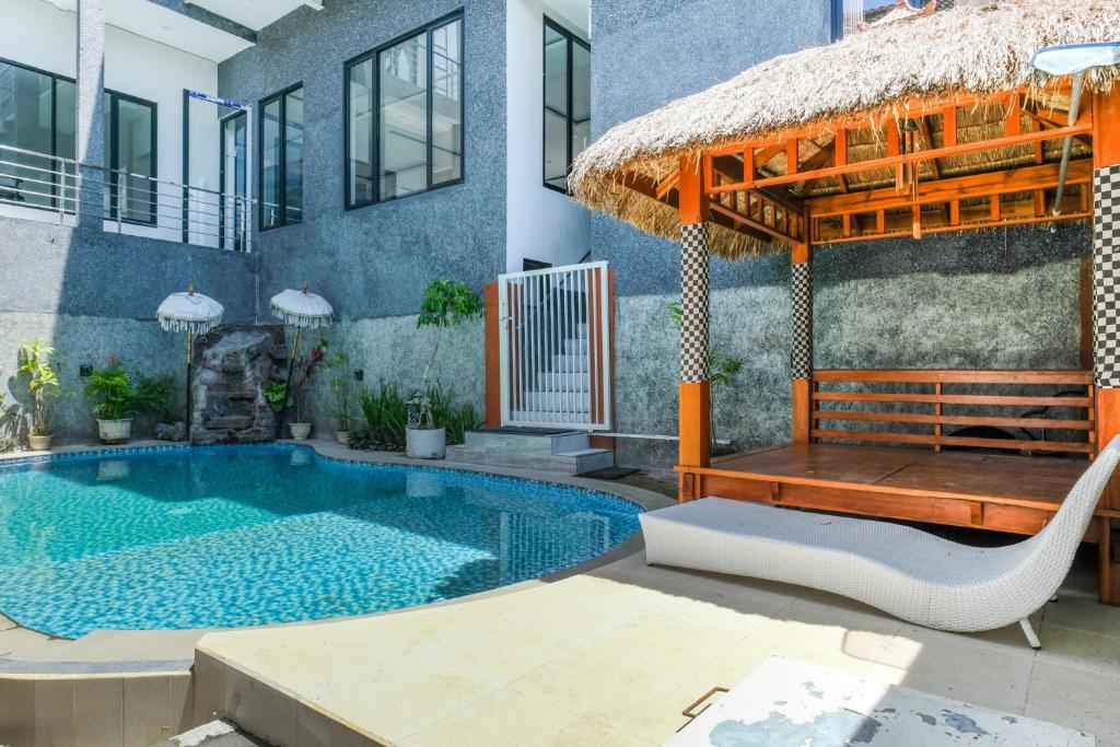 a house with a swimming pool and a gazebo at Urbanview Golden Barbie near Jawa Timur Park 2 in Tlekung