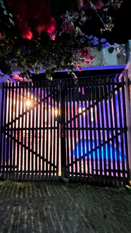 a gate with blue lights on it at night at Casa Sophi in Cruz