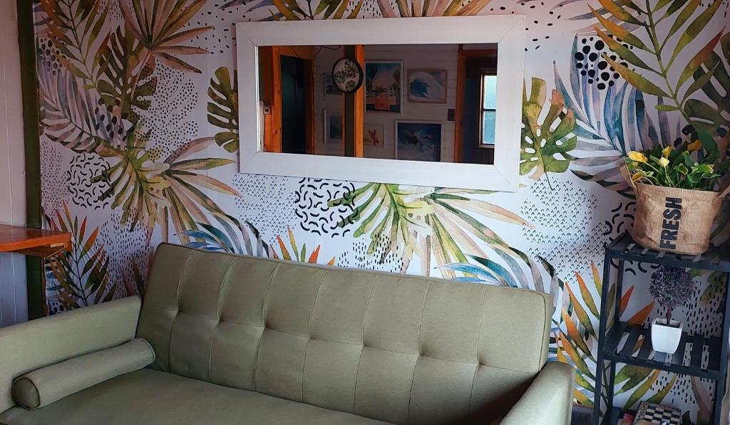 a living room with a couch and a mirror at Cabaña Chango in Coquimbo