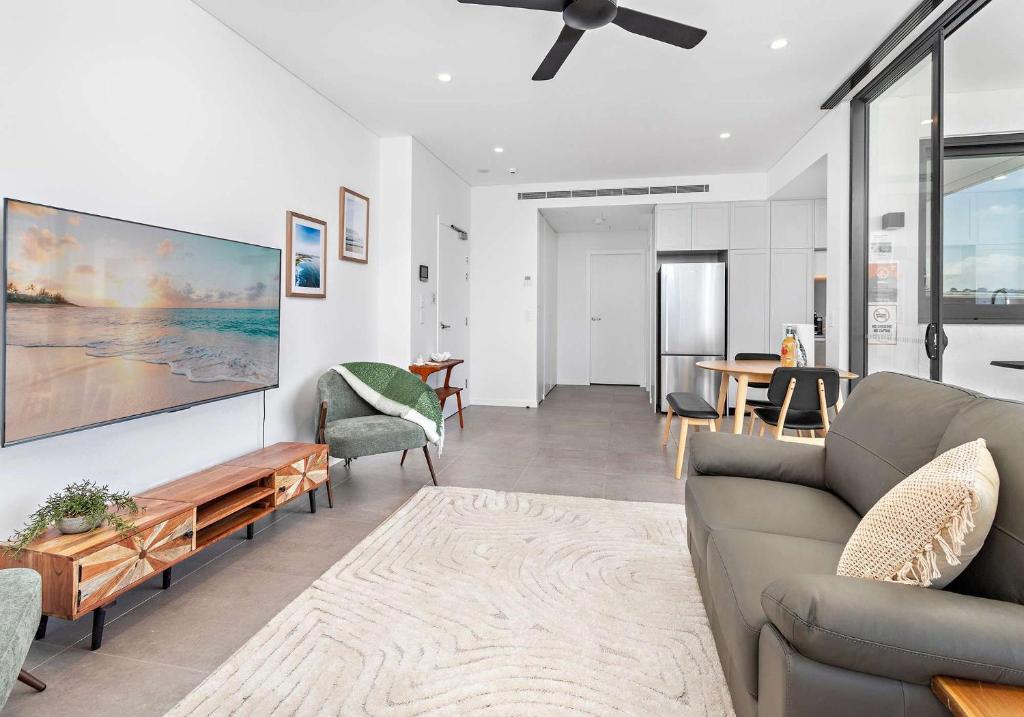 a living room with a couch and a table at Aqua Cove - Marina Escape in Shellharbour