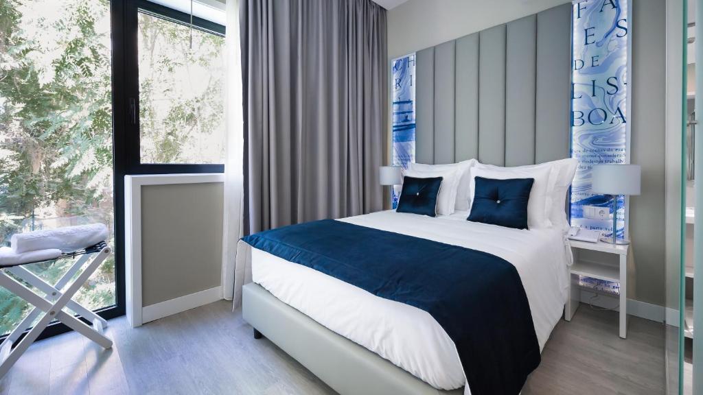 a bedroom with a large bed and a window at Lisbon Sao Bento Hotel in Lisbon