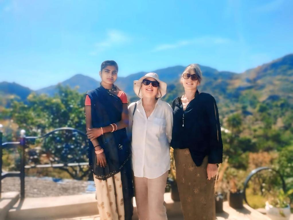 a group of three people standing next to each other at Nomada in Mount Ābu