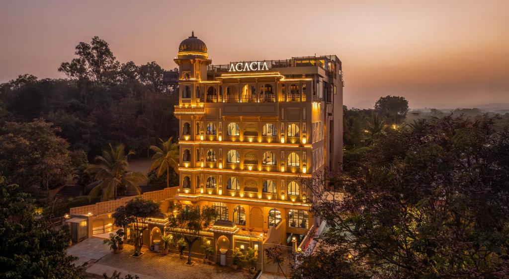 a large building with a clock tower in front of it at Acacia Somgarh Udaipur in Udaipur