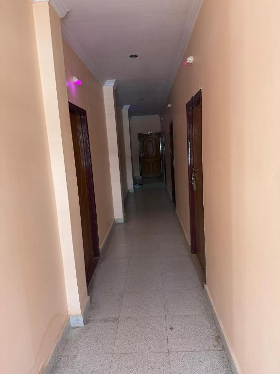 a hallway of a building with two doors and a tile floor at Surya lodge in Rāzole