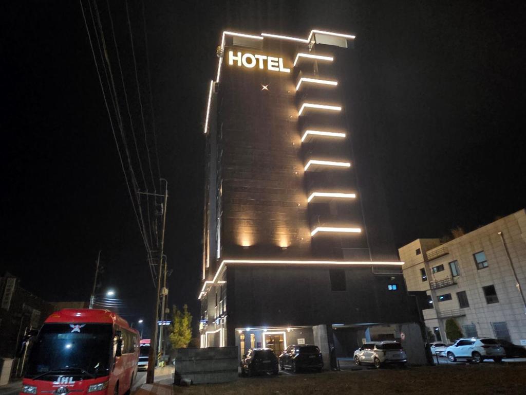 a hotel with a sign on the side of it at night at Jinju KAI Tourist Hotel in Jinju