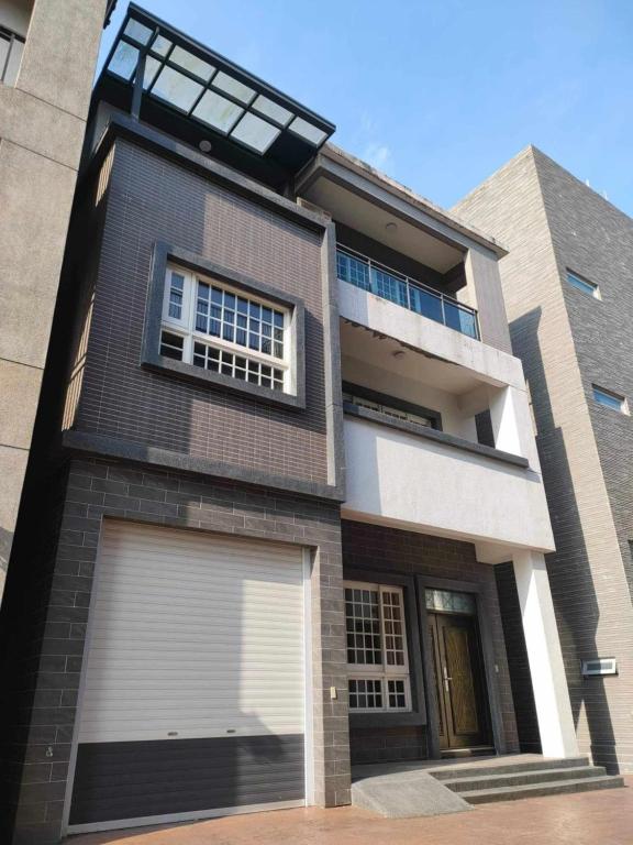 a large house with a garage and a window at Lan Cheng Su in Yuanshan