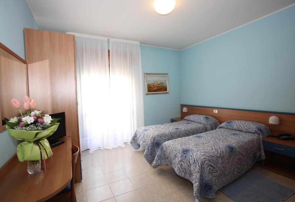 Postel nebo postele na pokoji v ubytování Albergo Ridente