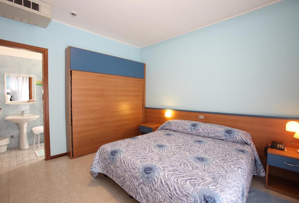 Postel nebo postele na pokoji v ubytování Albergo Ridente
