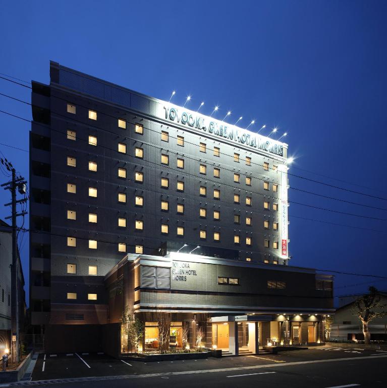 a tall building with lights on top of it at Toyooka Green Hotel Morris in Toyooka