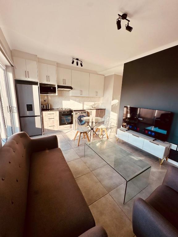 a living room with a couch and a table at Table Mountain View Apartment II in Cape Town
