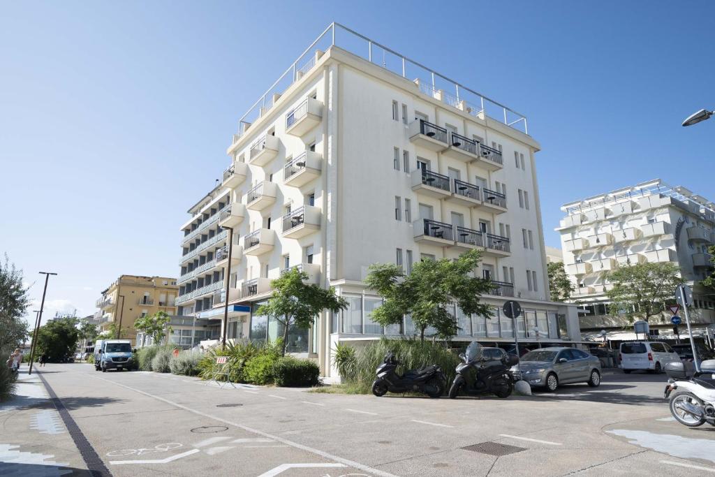 a white building with motorcycles parked in front of it at Hotel Seaview in Rimini