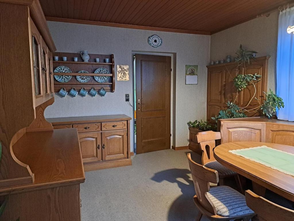 a kitchen with a wooden table and wooden cabinets at Ferienhaus mit Garten in Traiskirchen
