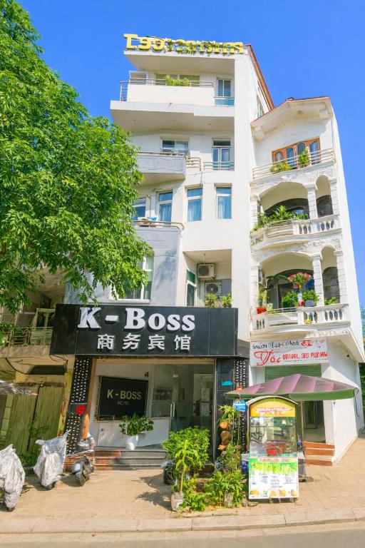 a tall white building with a store in front of it at K-BOSS Hotel in Bắc Ninh