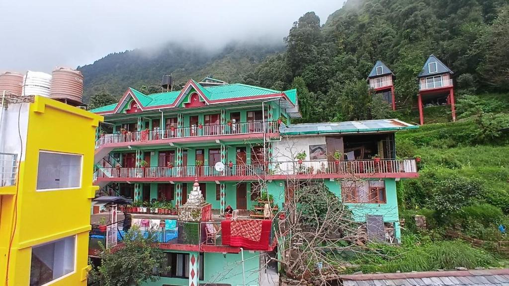 a group of houses with balconies on a hill at DreamCatcher & Homestay in McLeod Ganj