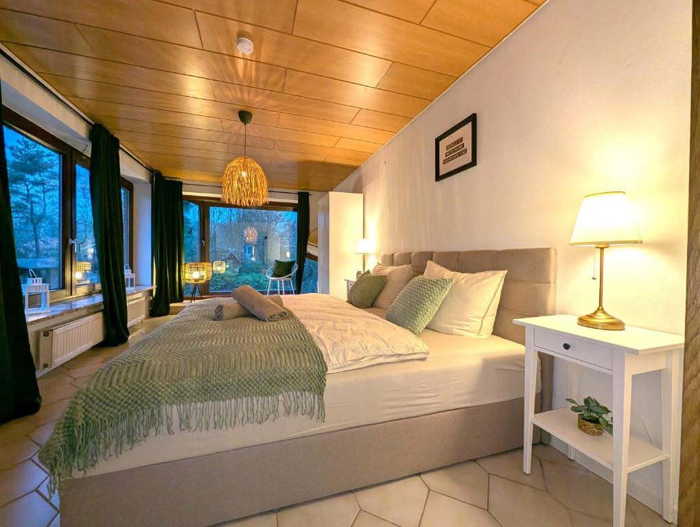 a bedroom with a large bed with a wooden ceiling at Heidezimmer in Bispingen
