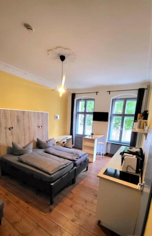 a bedroom with two beds and a desk in it at Apartments Kolo 77 in Berlin