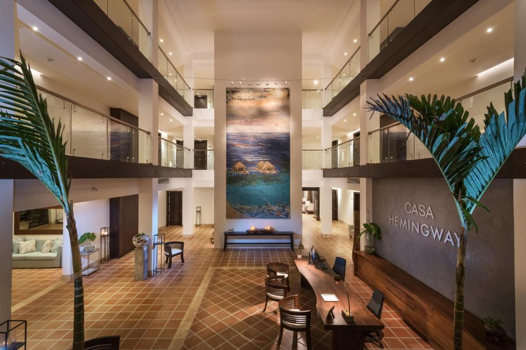 a lobby with a large painting on the wall at Hotel Casa Hemingway in Juan Dolio