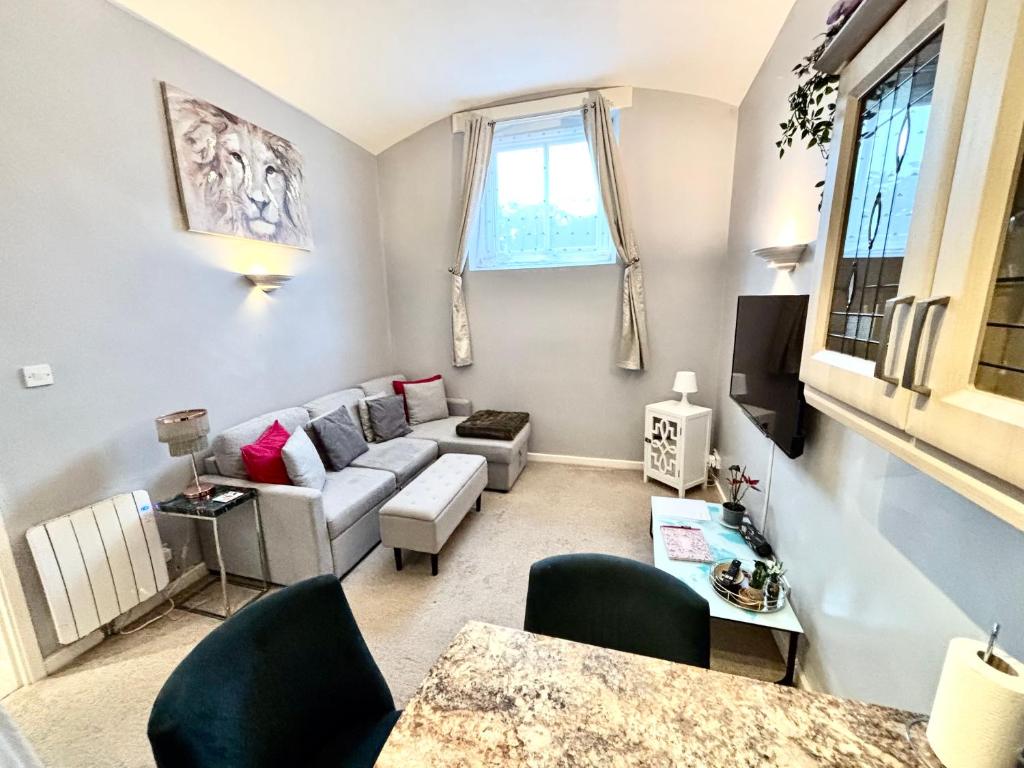 a living room with a couch and a table at Cosy County House apartment with free private parking Sleeps up to four guests in York