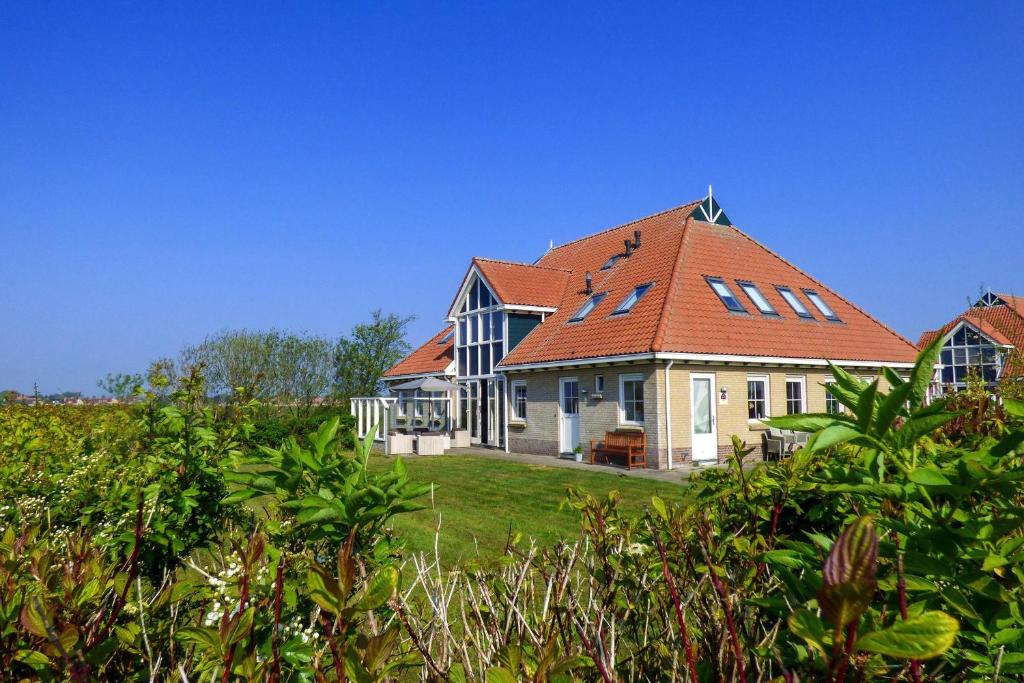 a large house with an orange roof at Waddenvilla 7 in Hollum
