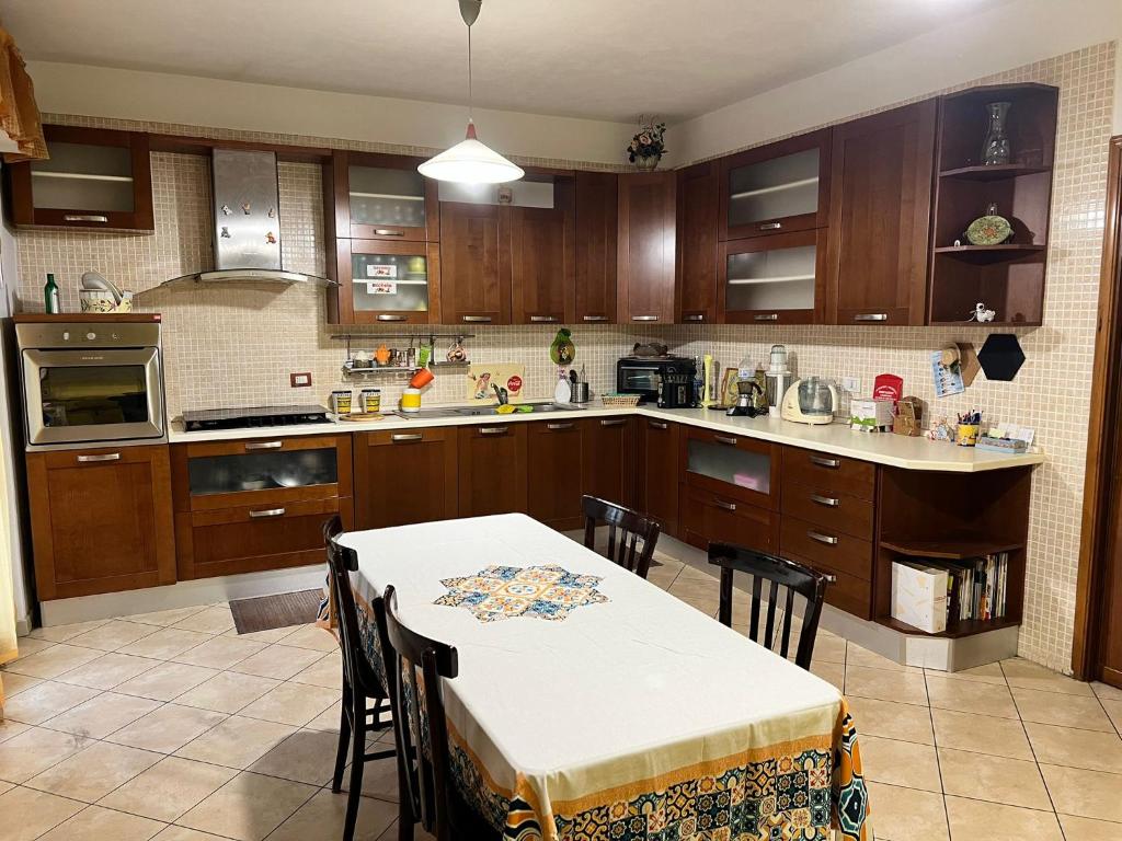 a kitchen with a table and a table and chairs at Cassiopea in Isnello