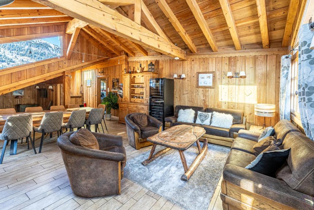a living room with couches and a table at Chalet les trois coeurs in Méribel