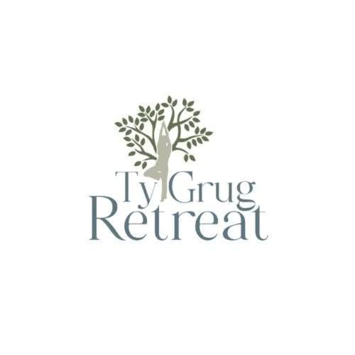 a tree logo with the words ivy giving retreat at Ty Grug Retreat in Little Newcastle