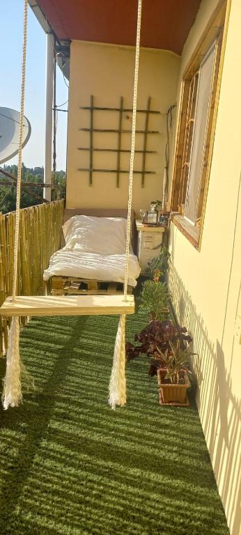 a porch with a porch swing on a house at Lankaran house in Lankaran