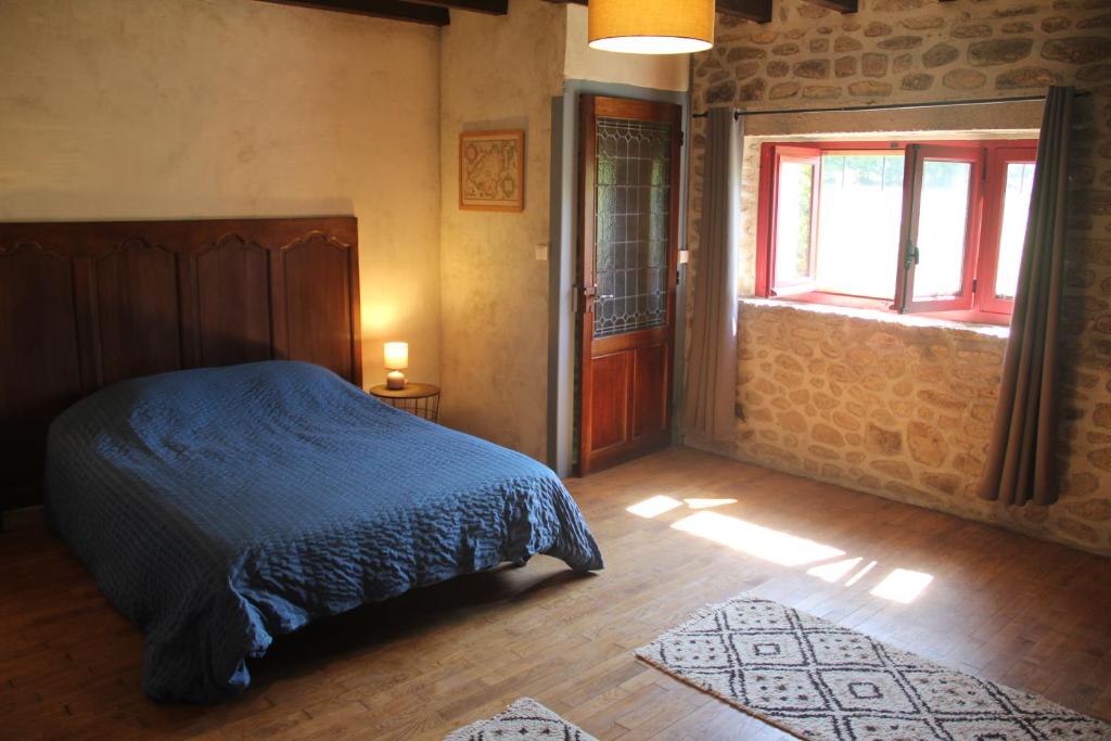 a bedroom with a bed and a window and a door at Gîte Charlange in Pradelette