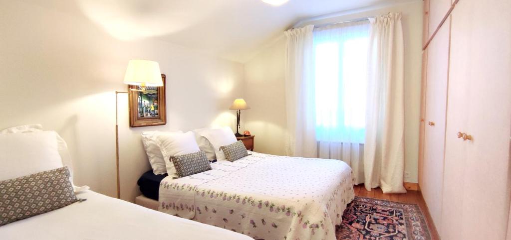 a bedroom with two beds and a window at PARIS AUTHENTIC HOUSE Métro 7 Pierre et Marie Curie in Paris