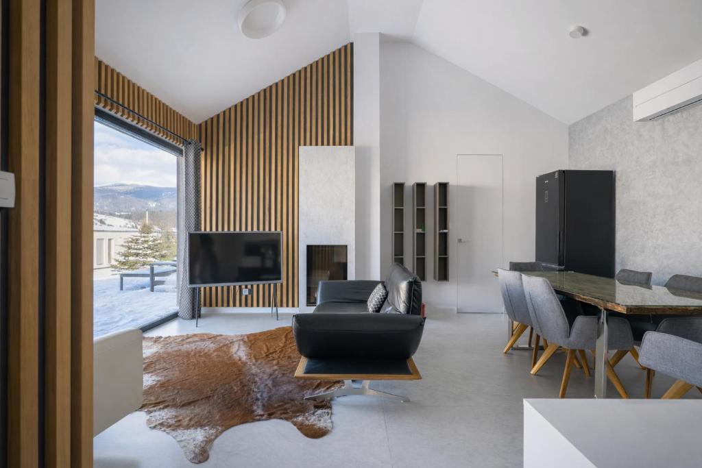 a living room with a couch and a table at Chalet Rufux in Dolná Lehota