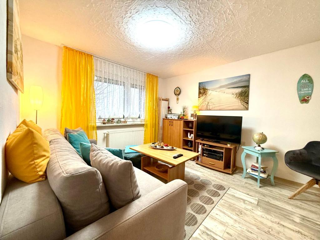 a living room with a couch and a television at Ferienwohnung Am Blessberg in Stelzen in Eisfeld
