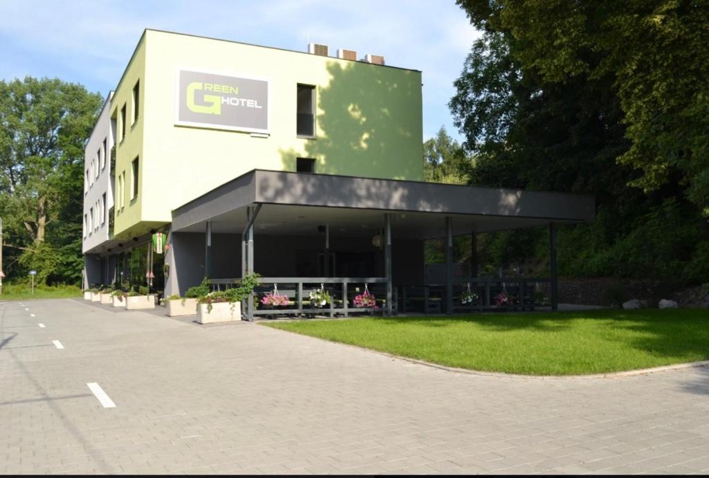 a building with a sign on the side of it at GREEN HOTEL Ostrava in Jáma František