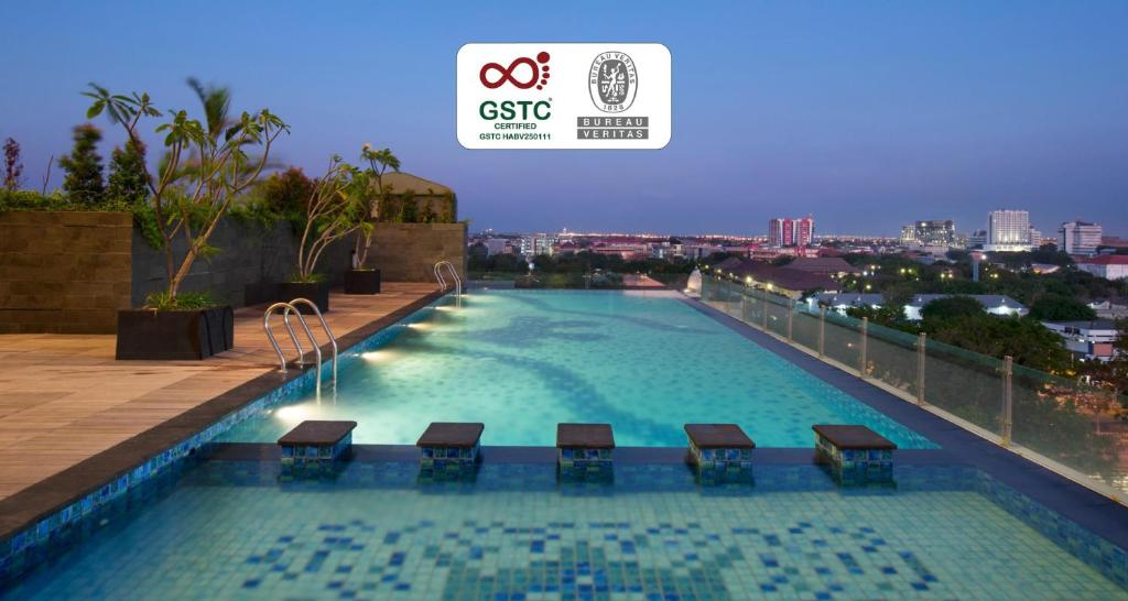 a large swimming pool on the roof of a building at Best Western De Papilio in Surabaya