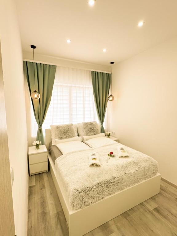 a bedroom with a large bed and a window at VIBE S31 Apartman ,AC,Free Parking in Székesfehérvár