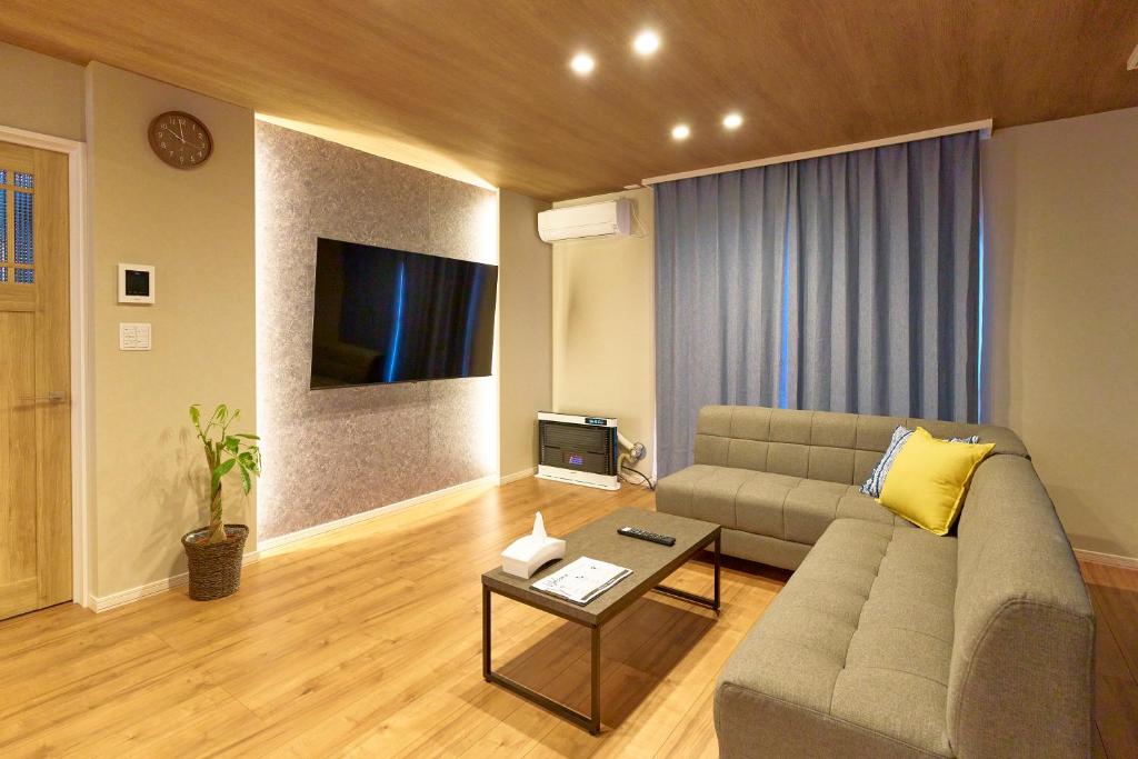 a living room with a couch and a table at Imari in Asahikawa
