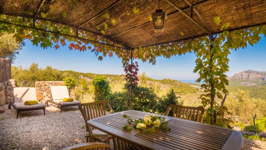 a table and chairs on a patio with a view at Ca's Xorc Luxury Retreat - ADULTS ONLY in Sóller