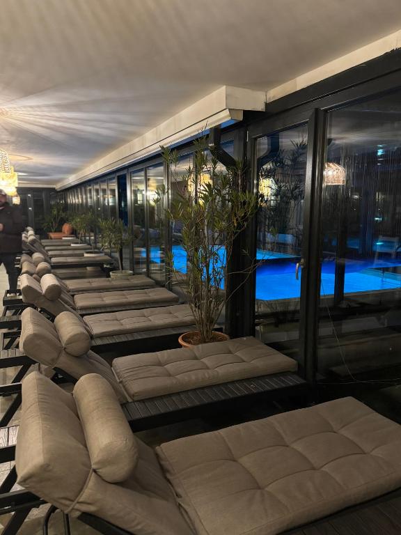 a row of chaise lounges in a hotel lobby at La Mosie in Haţeg