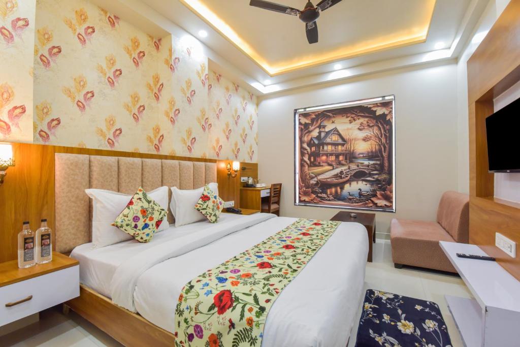 a hotel room with a bed and a tv at INDRA PALACE Unit 2 in Jaipur