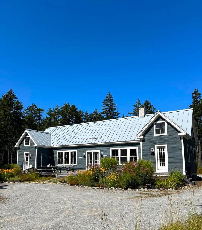 a gray house with a metal roof at Shackmatack in Tenants Harbor