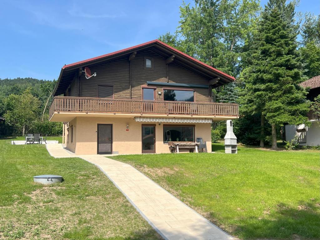 a large house with a balcony and a walkway at Haus 44 Feldblick in Arrach