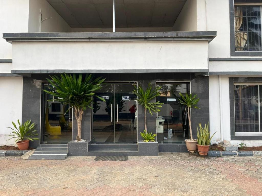 a store front with potted plants in front of it at Mobile Unique Apt in Ikeja