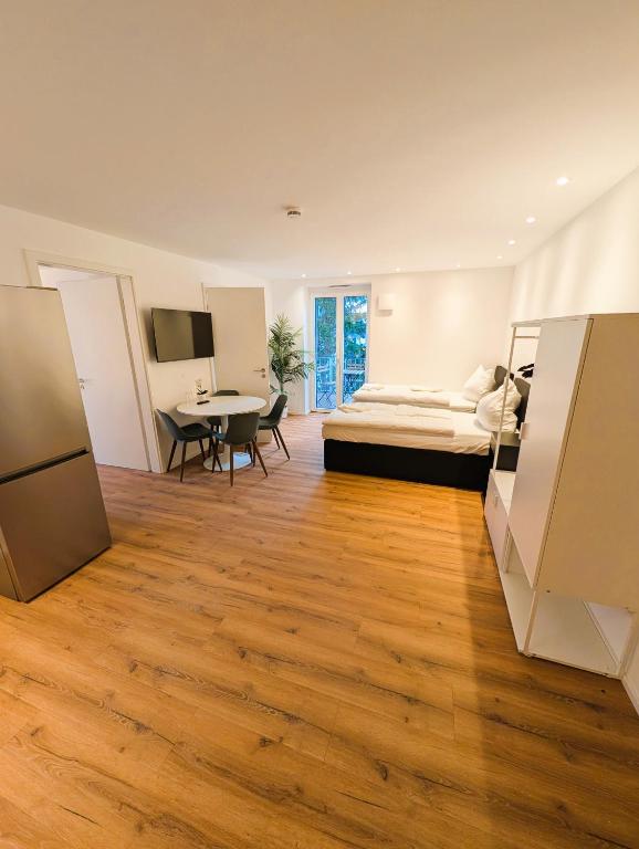 a large room with a bed and a table at Montelio Living in Ettlingen