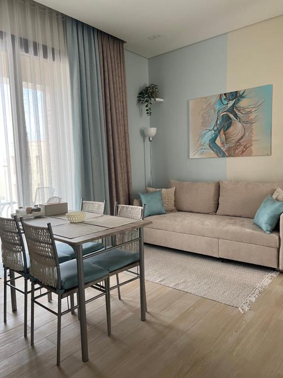 a living room with a table and a couch at Oriole Havana Salalah in Salalah